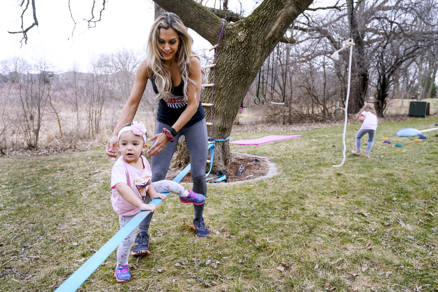 Yarizett Breunig playing with daughters in back yard